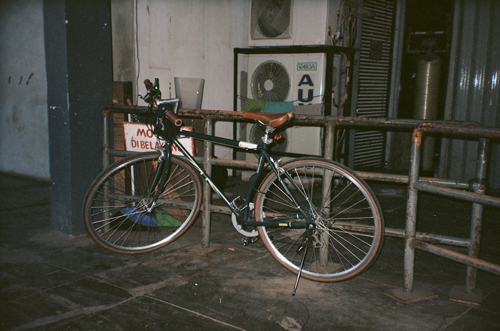 black and white bike near black railings