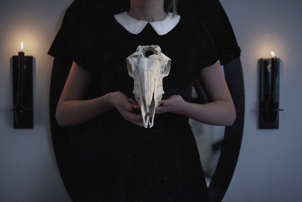 woman holding animal skull