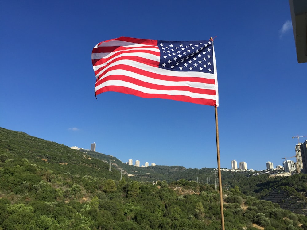 a large american flag flying in the wind