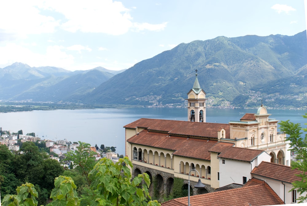 cathedral near body of water near mountain at daytime