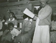 Children and elders listening together to the device in a cozy home setting