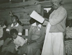 Children and elders listening together to the device in a cozy home setting