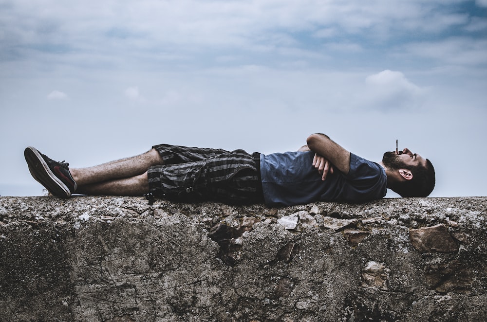 man lies in pavement