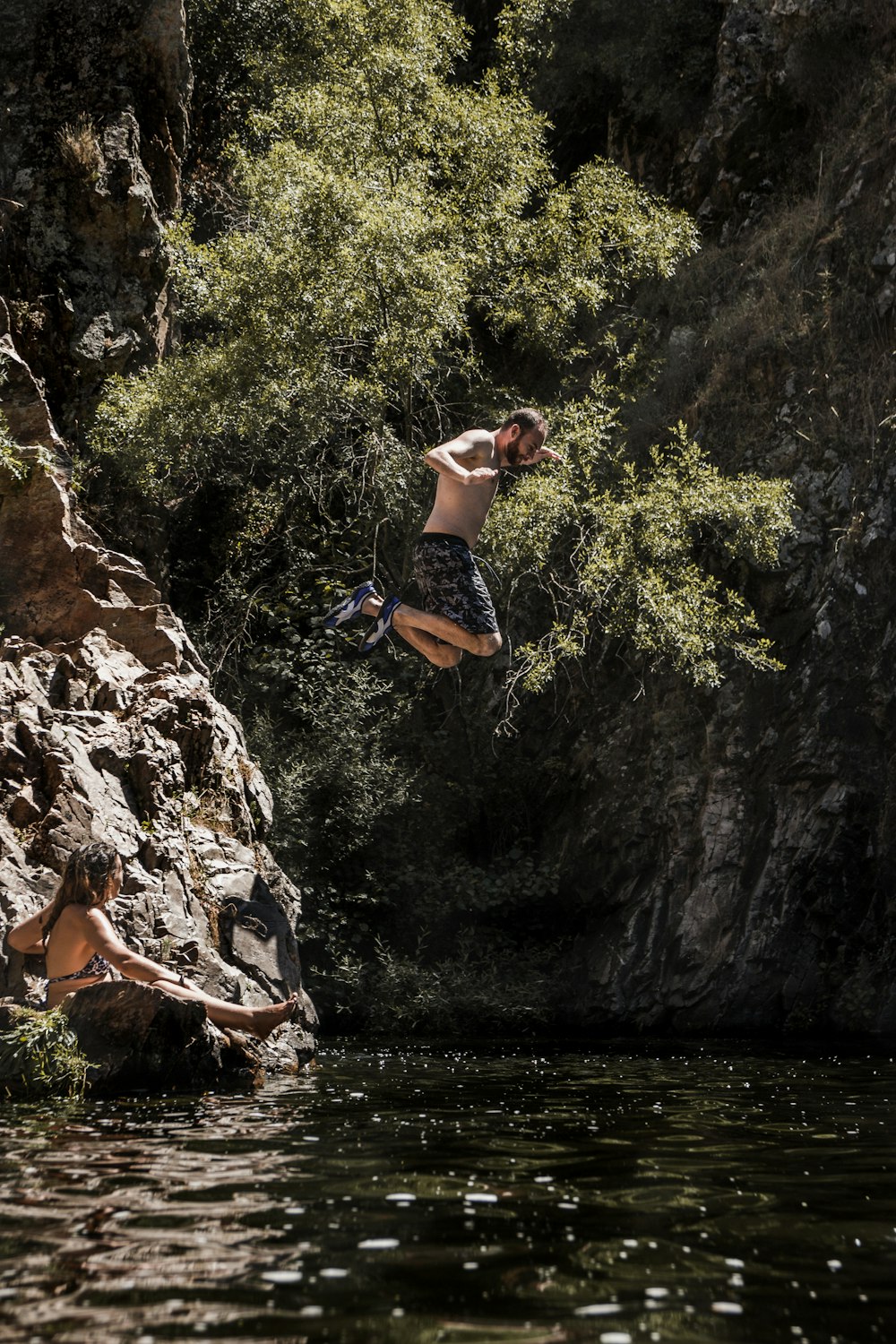 man jumping into the river
