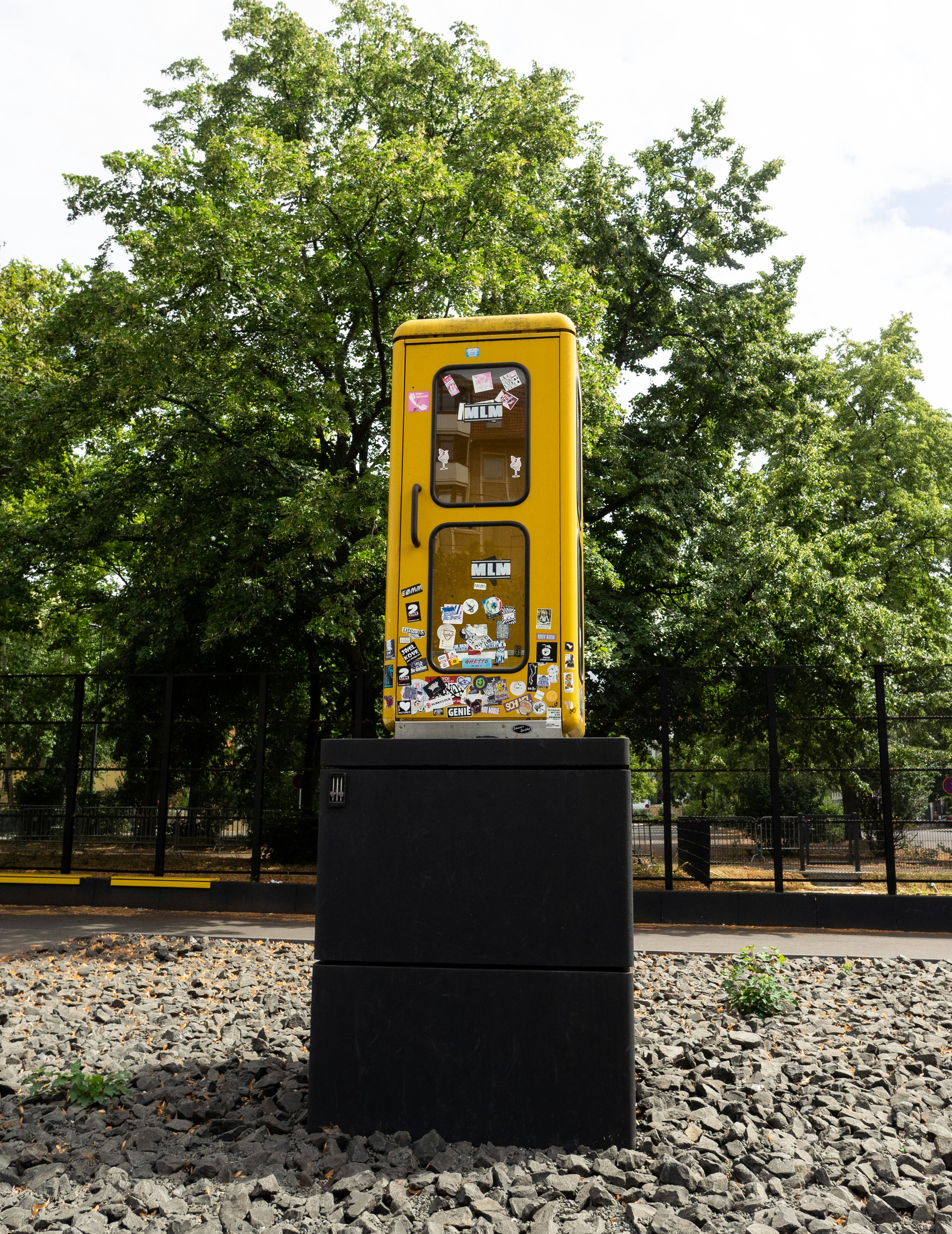 A yellow and black box sitting on top of a pile of rocks photo Free