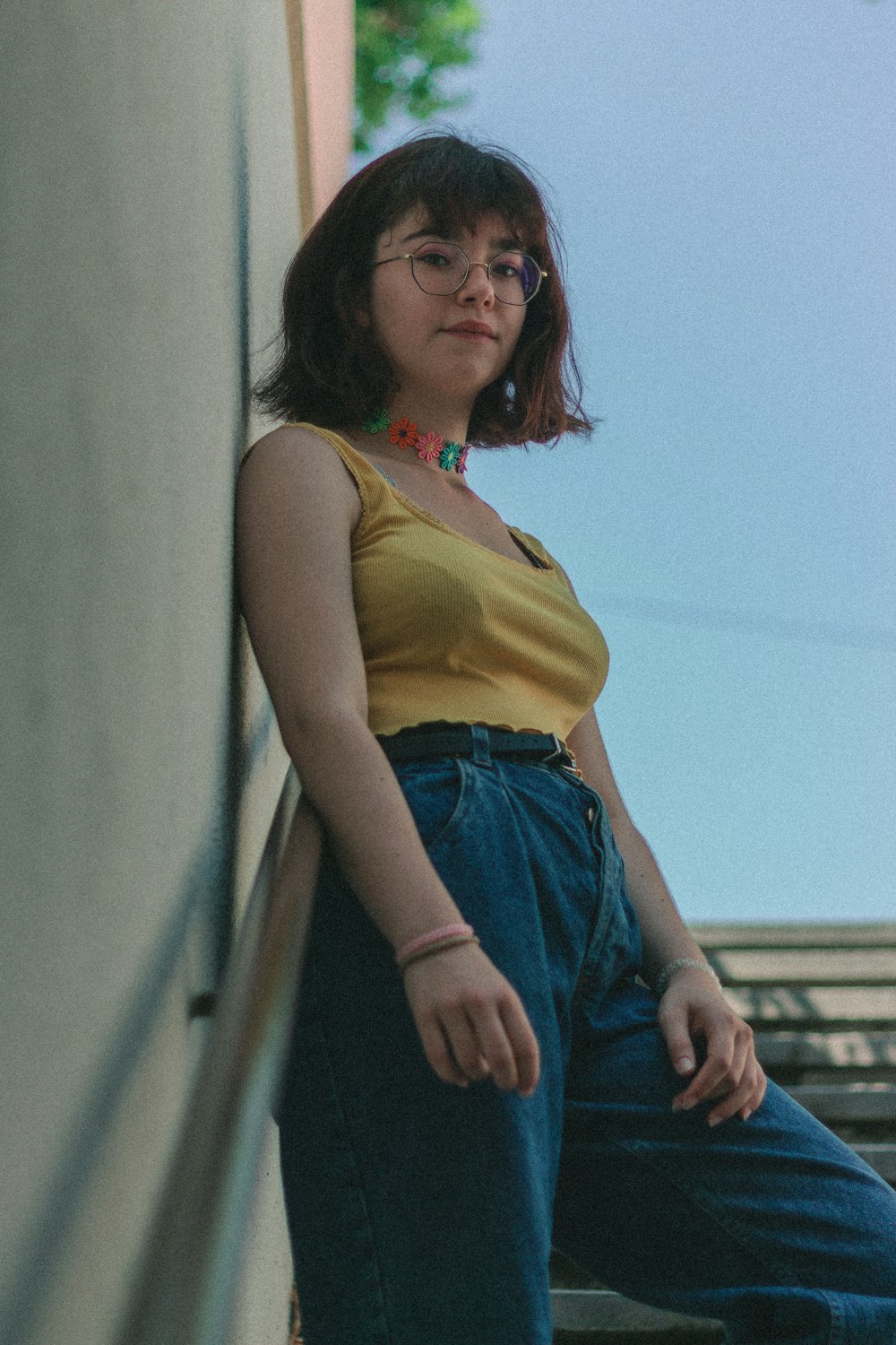 woman standing on stairs leaning on wall