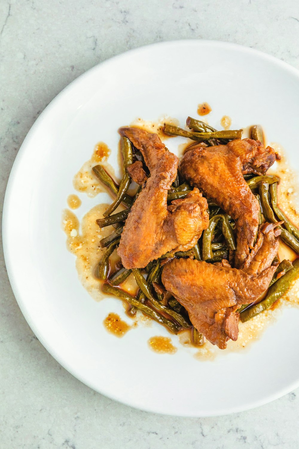 fried chicken wings in round white ceramic plate