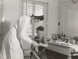 A caring nurse assisting a patient at home.
