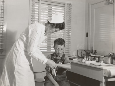A nurse carefully dressing a wound with gentle hands in a bright, clean room.