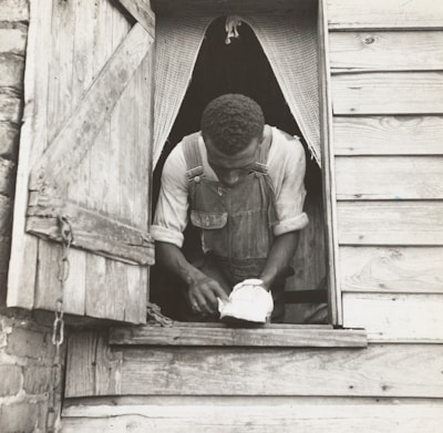 Worker using specialized tools to repair a window frame on a chilly day.