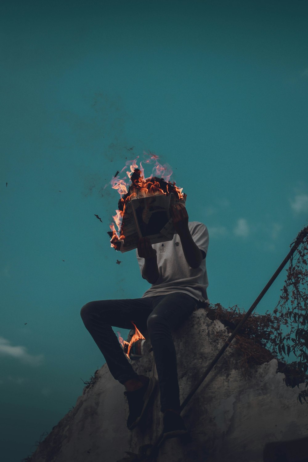 person holding burning book