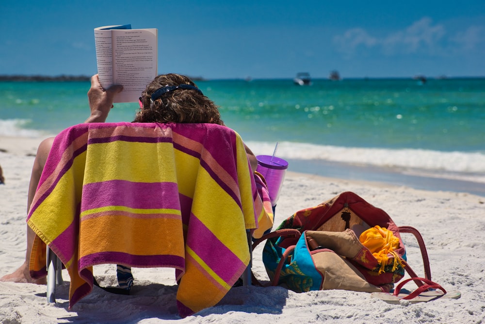 person sitting on seashore