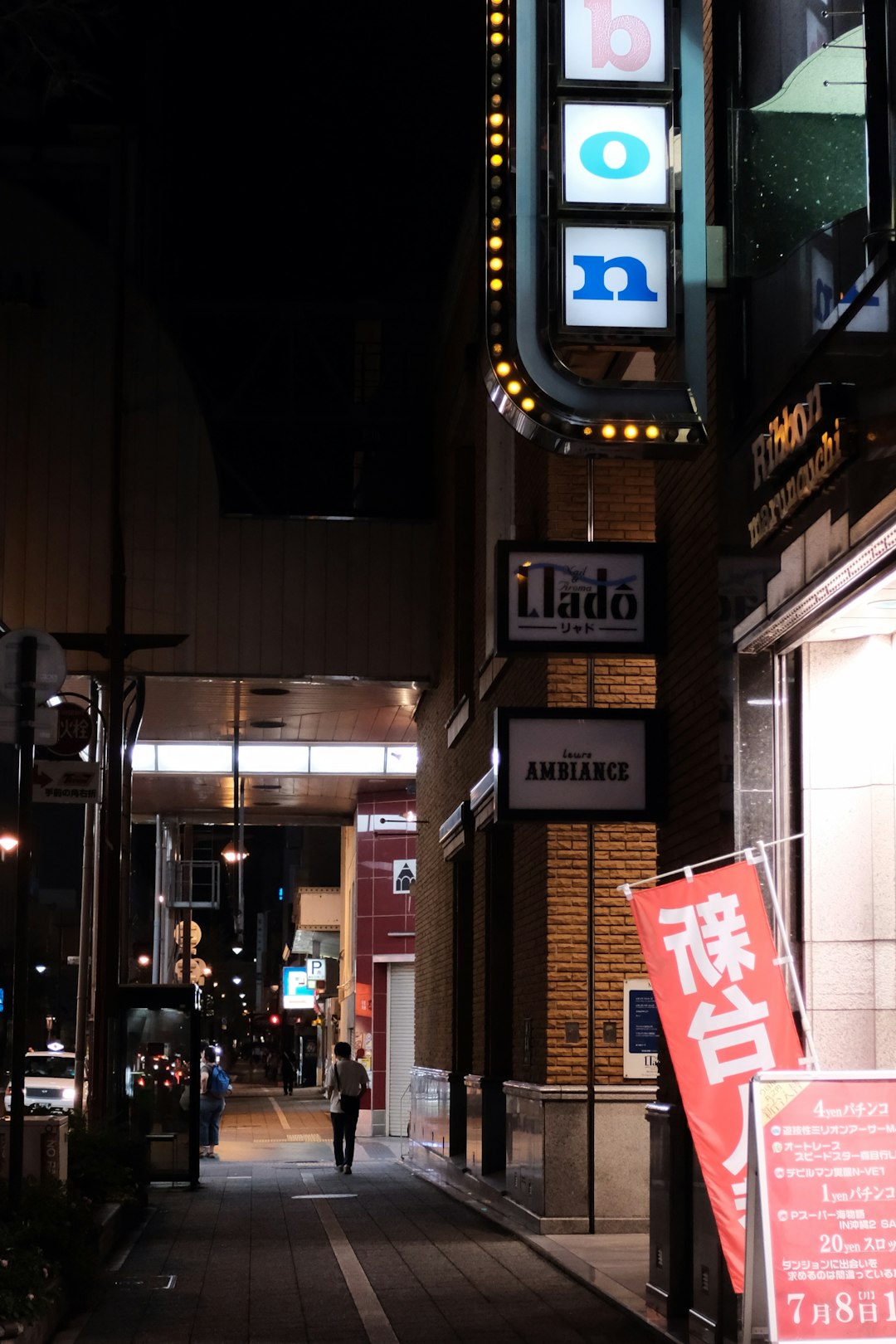 red and white signage during nighttime