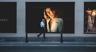 person walking near poster