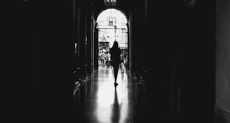 silhouette of person walking on hallway