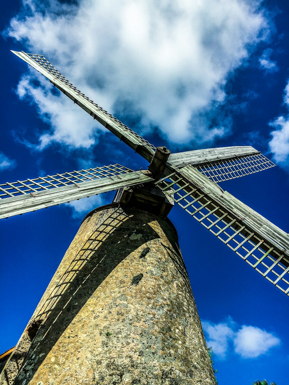 low-angle photo of white and brown windmill