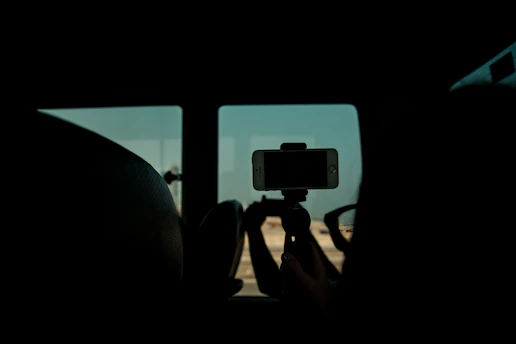 A sleek modern smartphone tripod set up by a window with natural light.