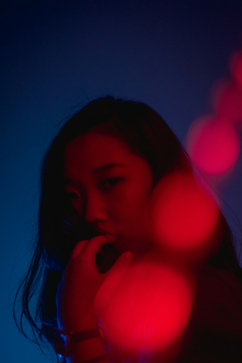 a woman standing in front of a red light