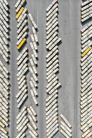A fleet of buses lined up neatly in a parking lot, showcasing their polished exteriors.
