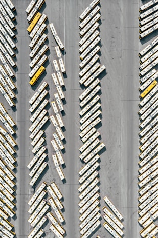 An aerial view of a fleet of buses lined up.