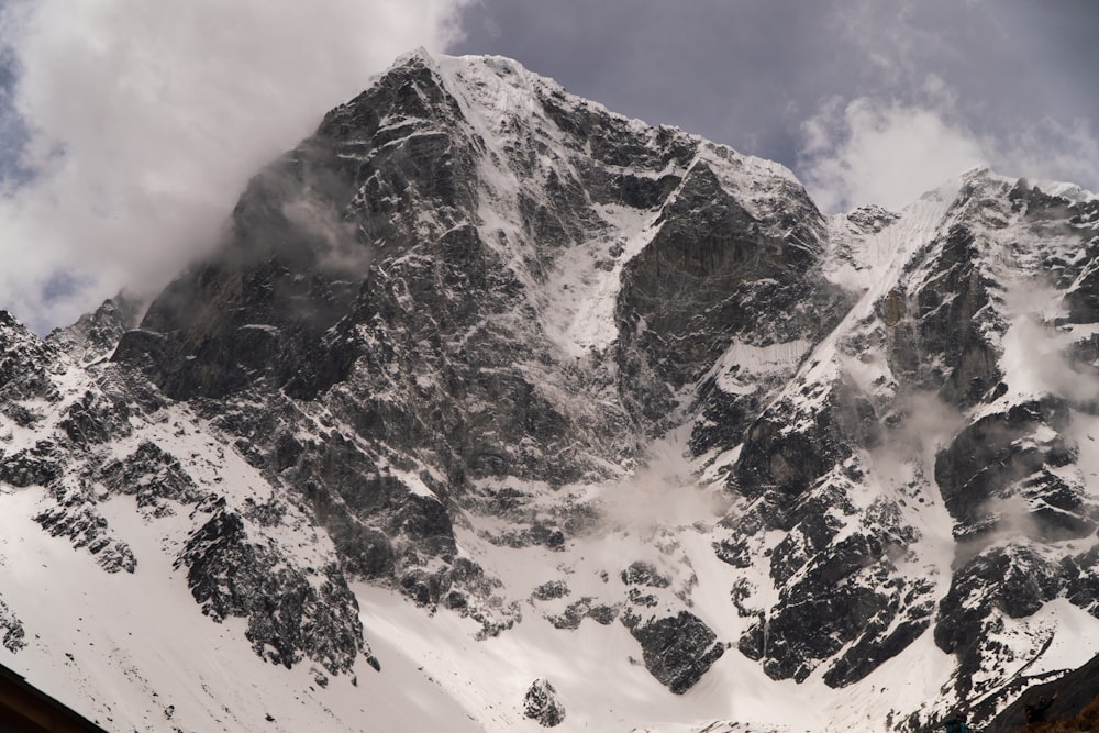 grayscale photography of mountain covered with snow