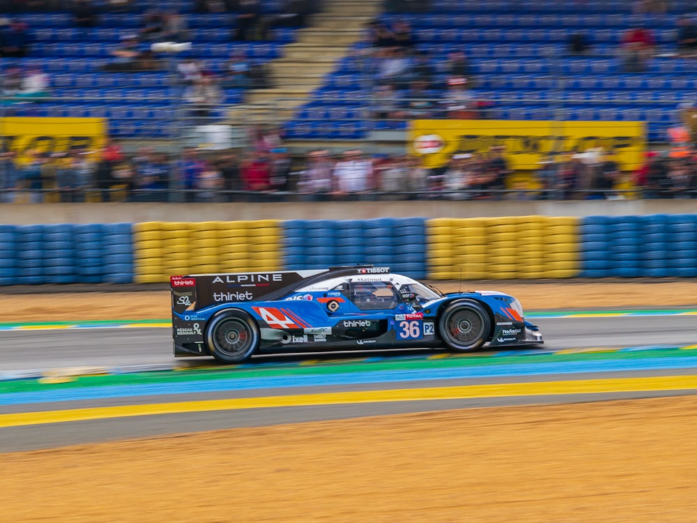 blue and black sports vehicle in road during daytime