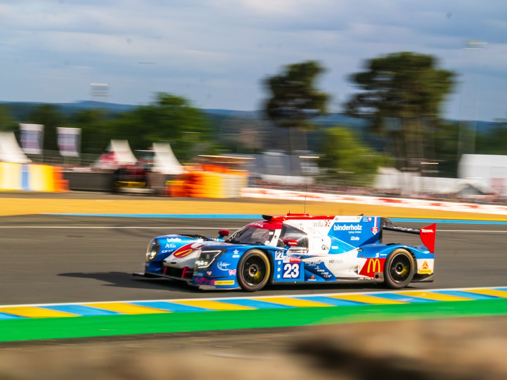 blue and white racing car on race track