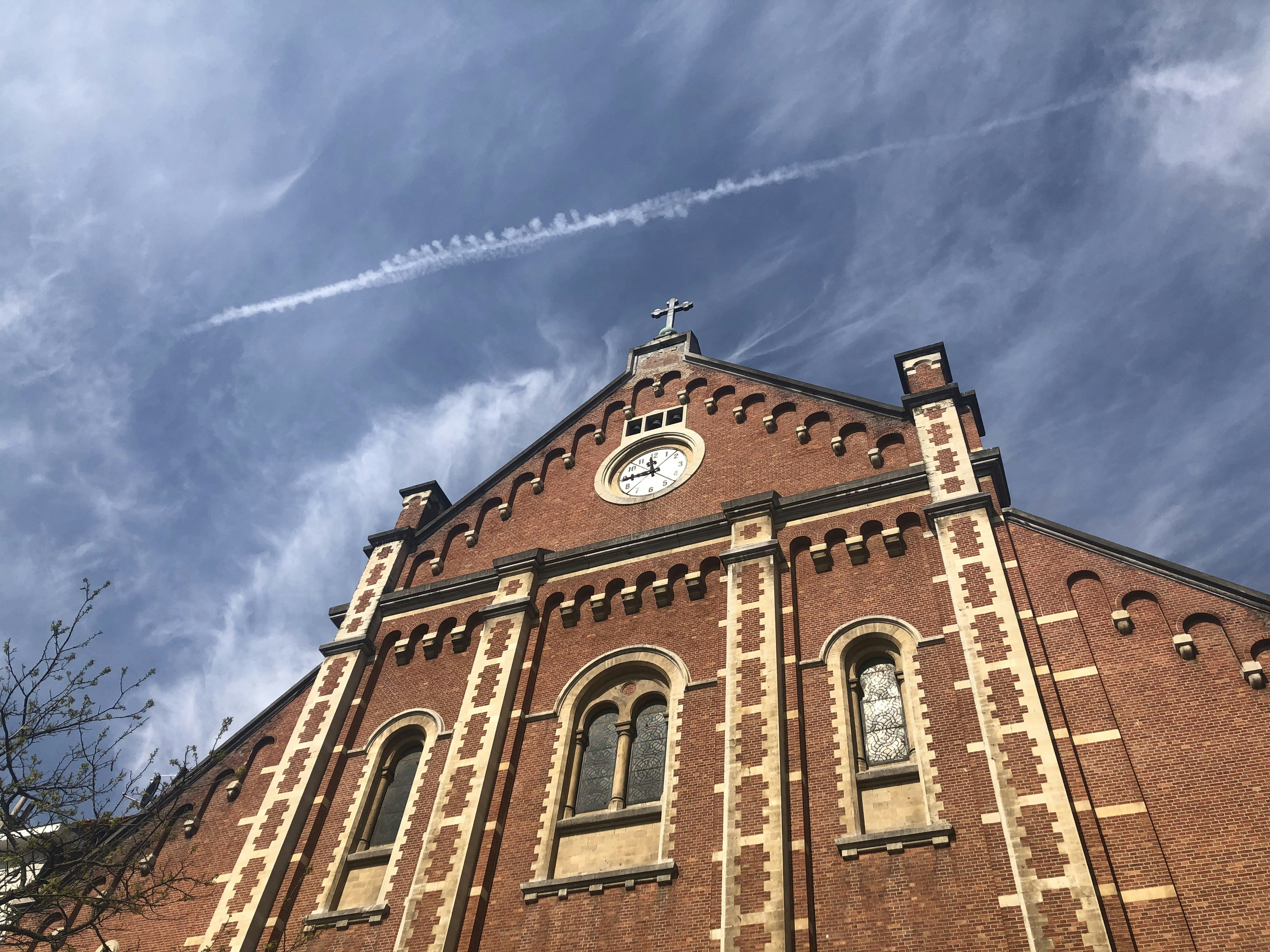 low-angle photography of red concrete cathedral