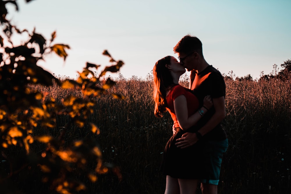 man and woman surrounded by grass