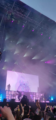 Robod5 performing live on stage with vibrant lights and an enthusiastic crowd.