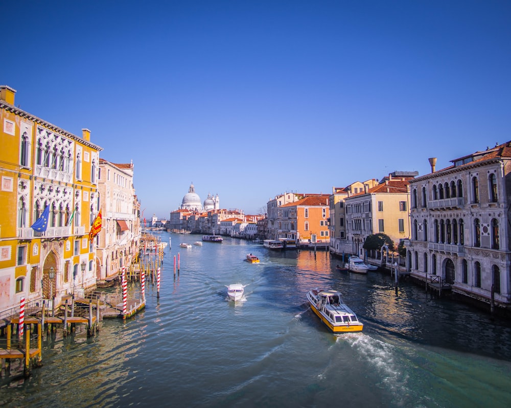 boat in body of water between buildings