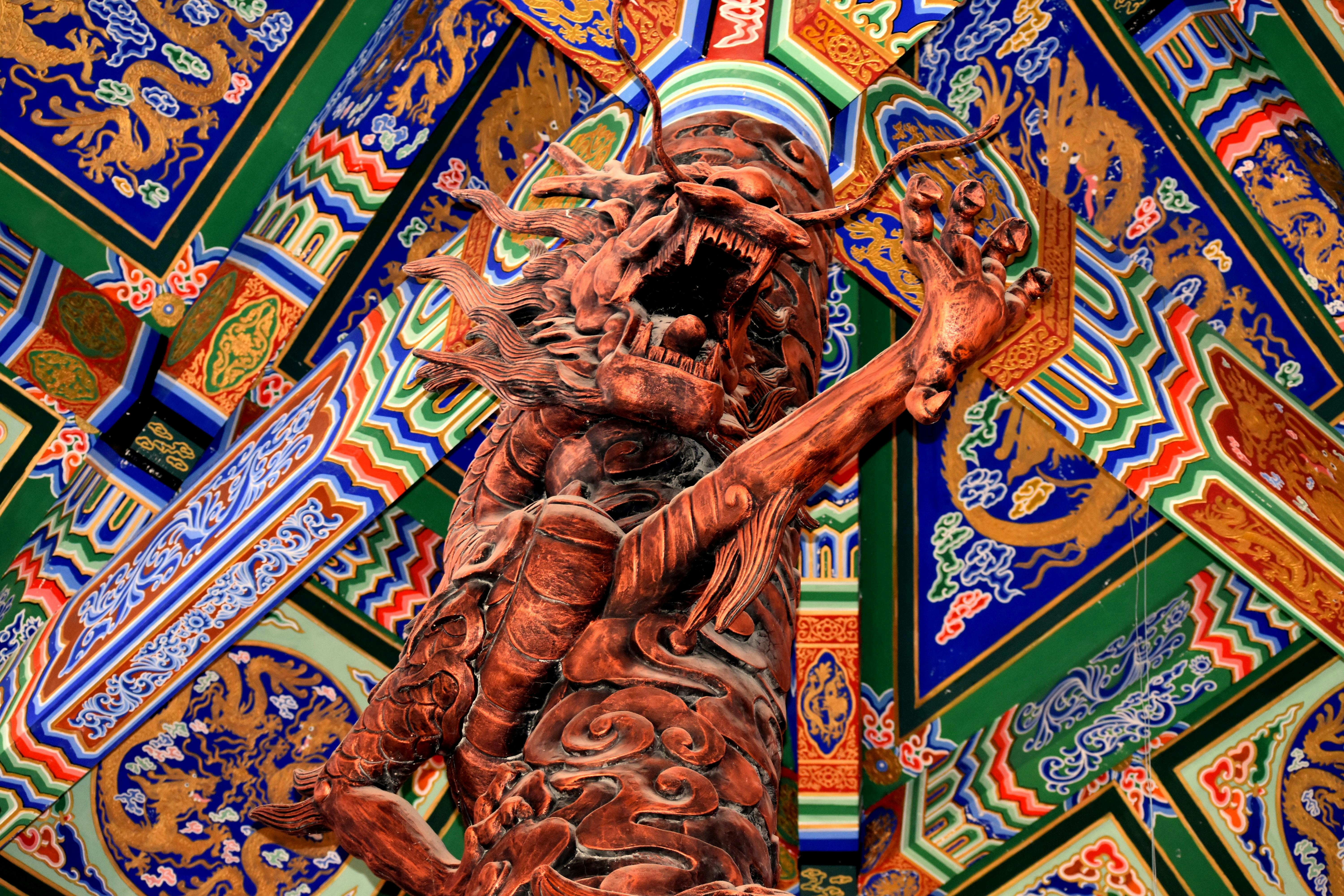 a sculpture of a man holding a bird on top of a building