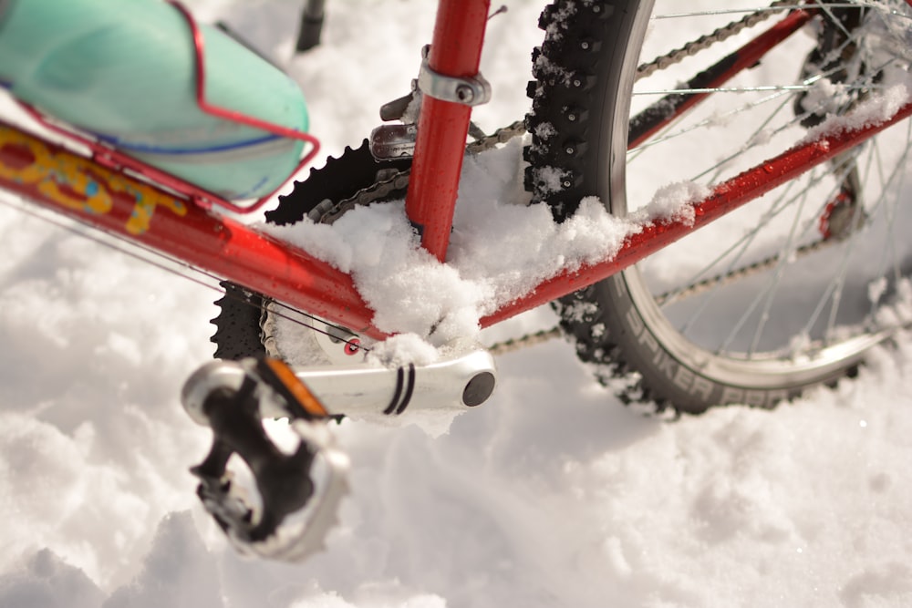 red bicycle on snow covered area