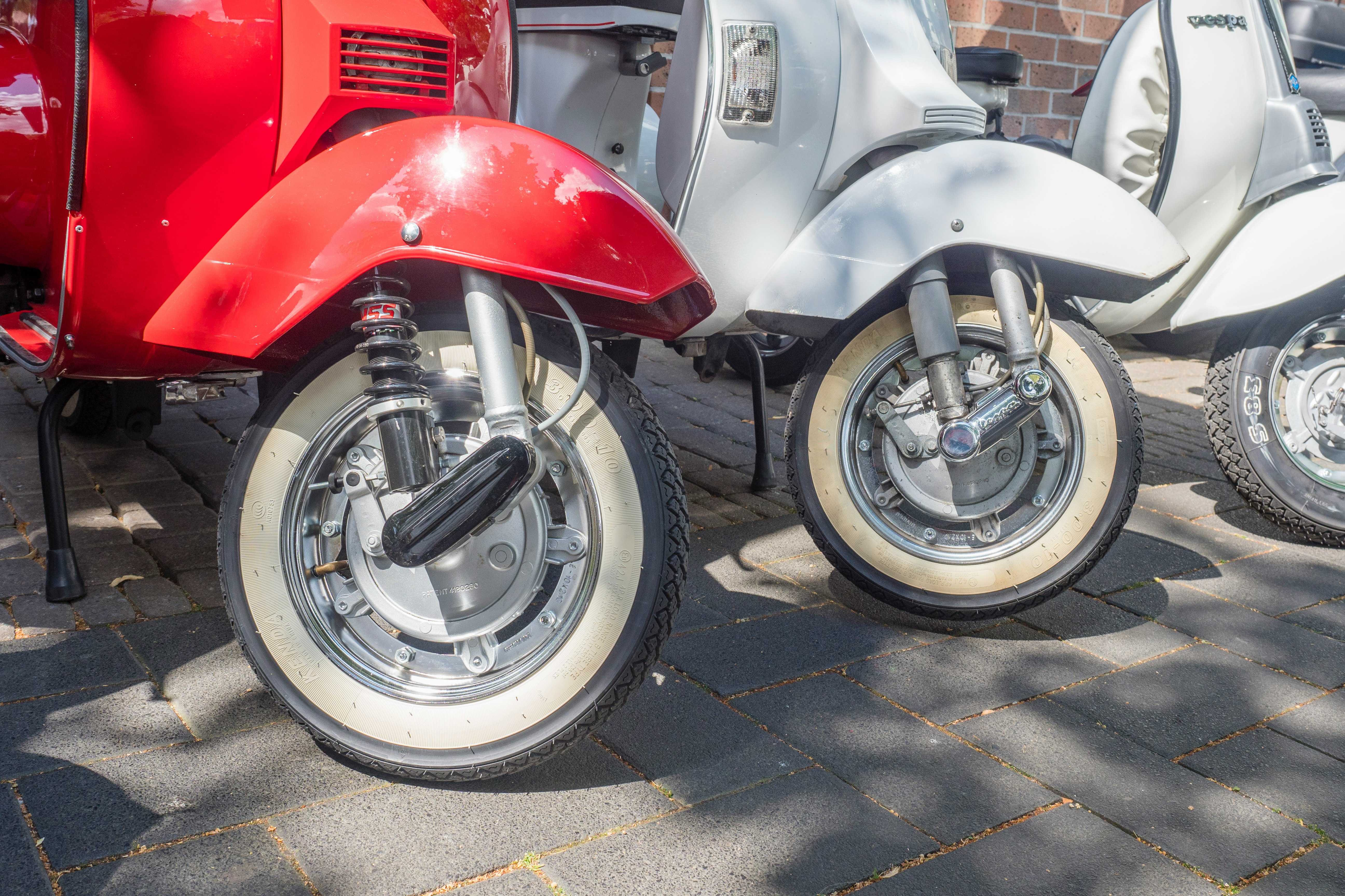 white and red motor scooters