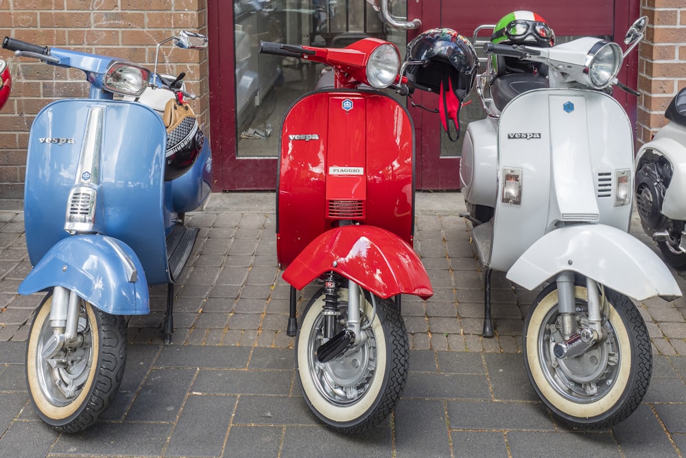 three motor scooters