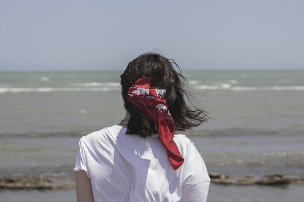 person wearing white shirt and red bandanna