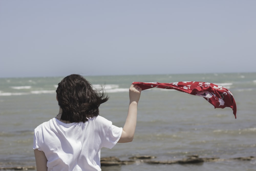 woman in white T-shirt holding red handkerchief