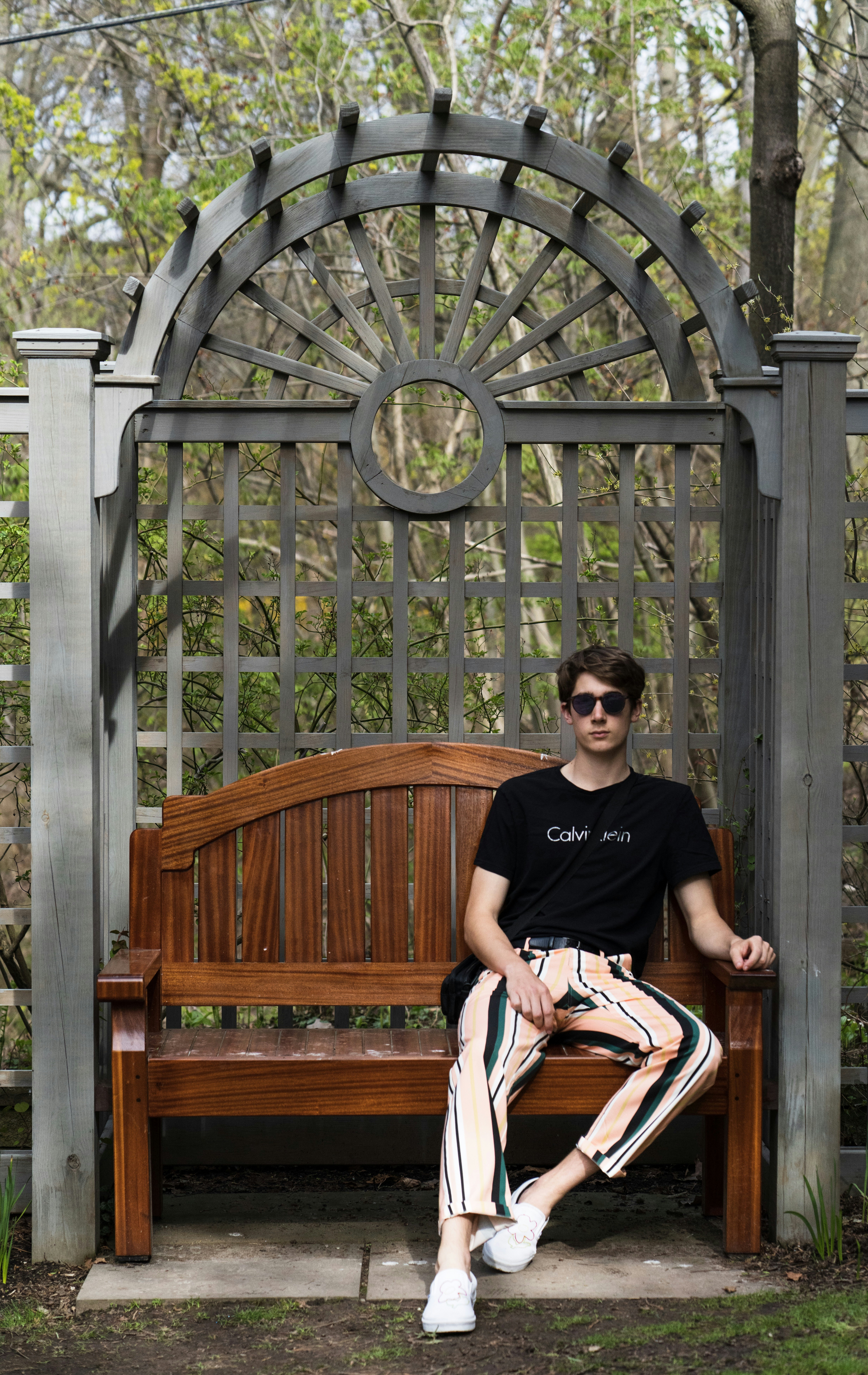 Man In Black Crew Neck T Shirt Sitting On Brown Wooden Bench Photo