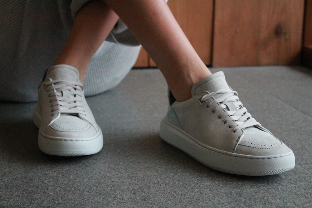 person in white sneakers