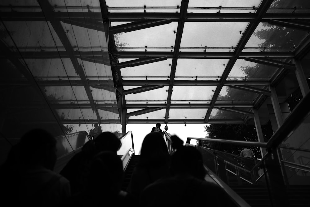 people on the stairs grayscale photo