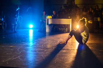 woman sitting on stage