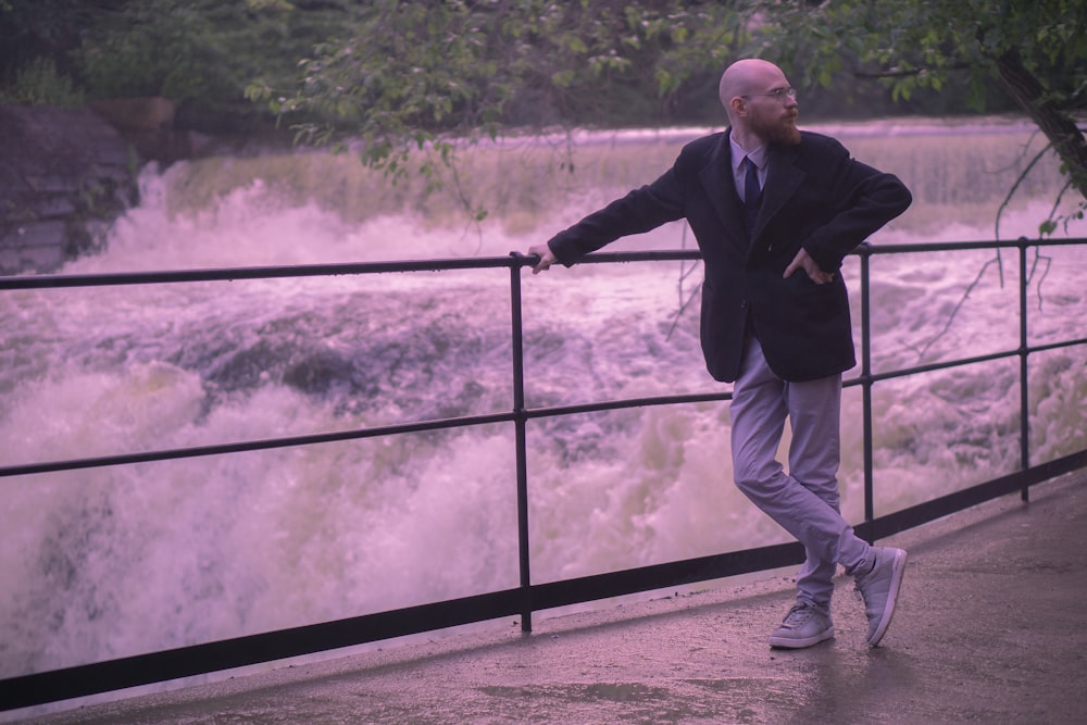 man standing leaning on the railing