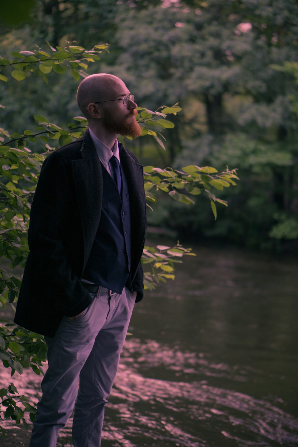 man standing near river