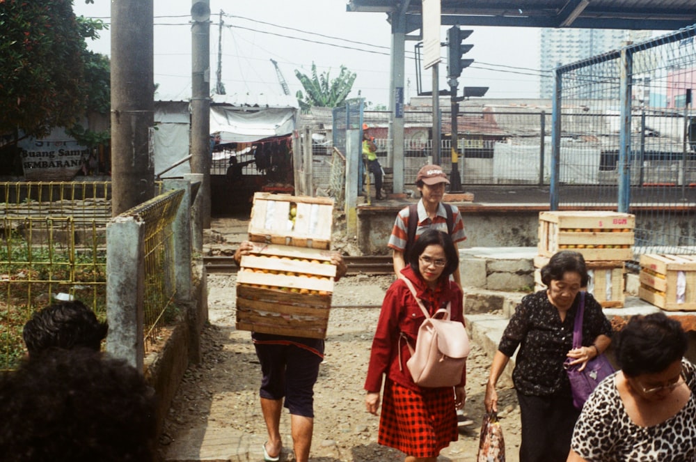 people walking on pathway near buildings during daytime