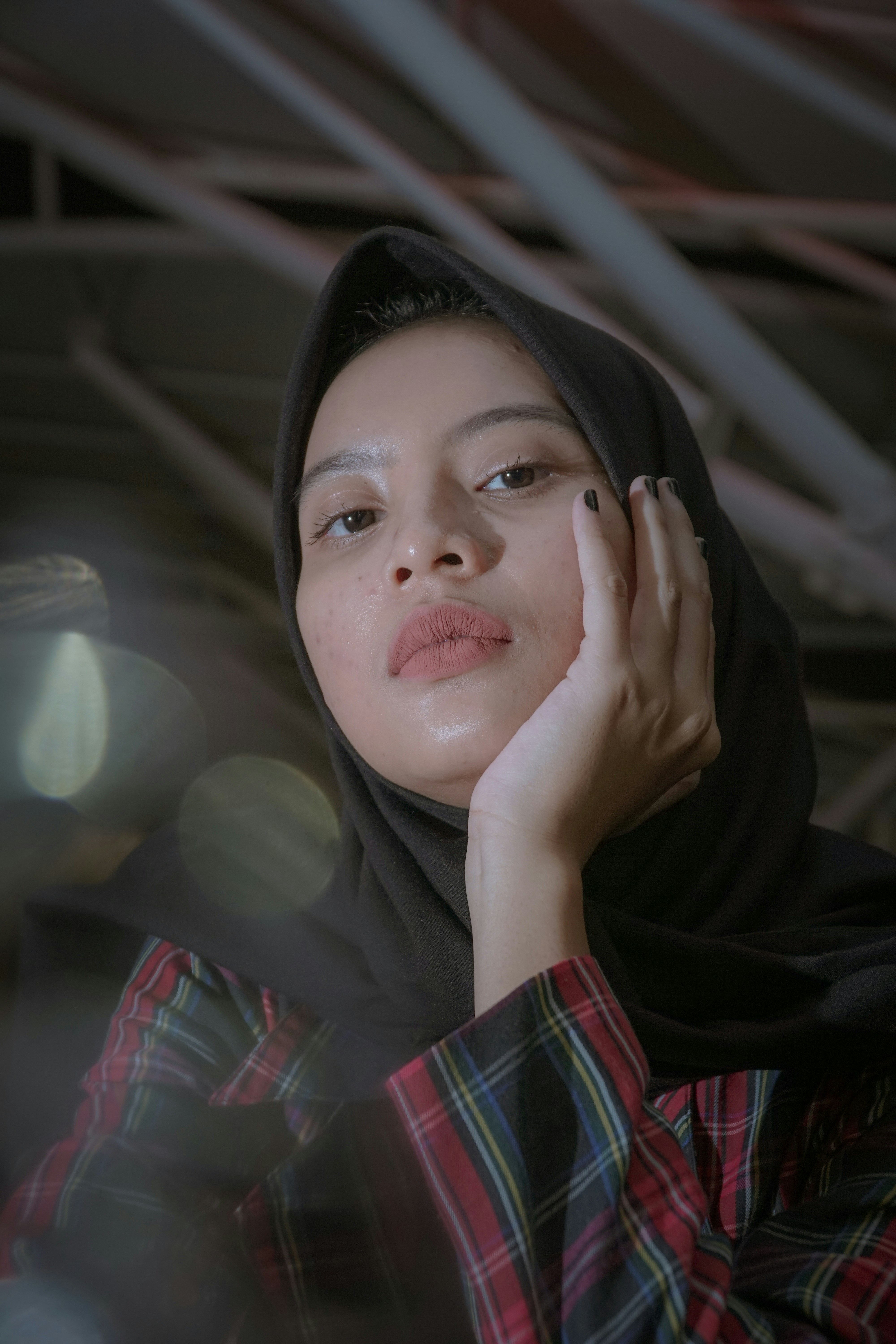 woman with left hand on her chin