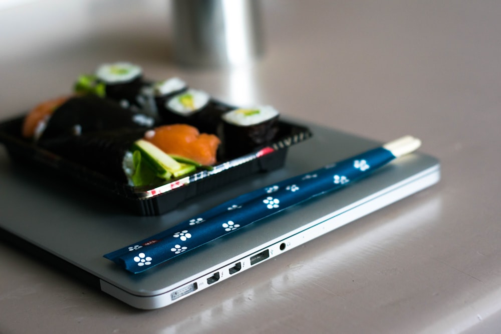 blue and white textile on gray laptop