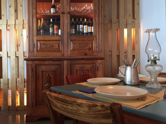 A beautifully set stone dining table with a matching wine cabinet in a cozy dining room.