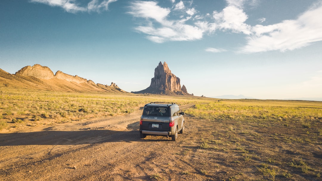 black SUV on dirt road at daytime,