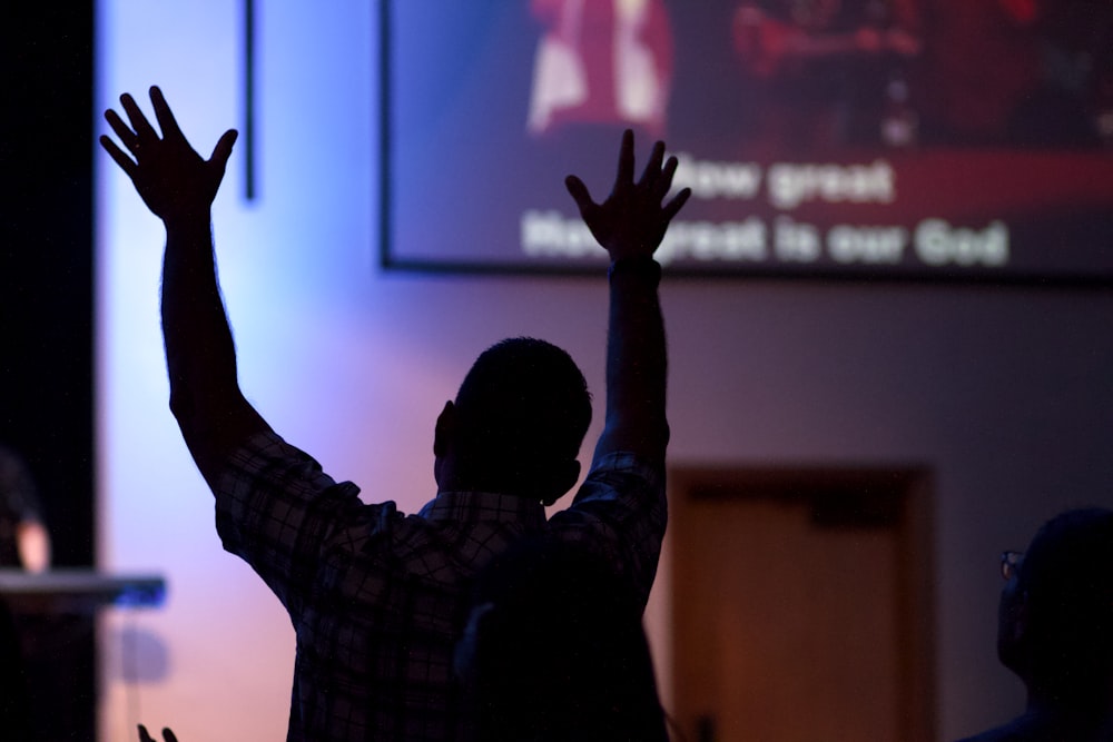 man raising his hands