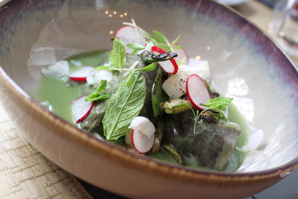 green salad in a white and brown bowl